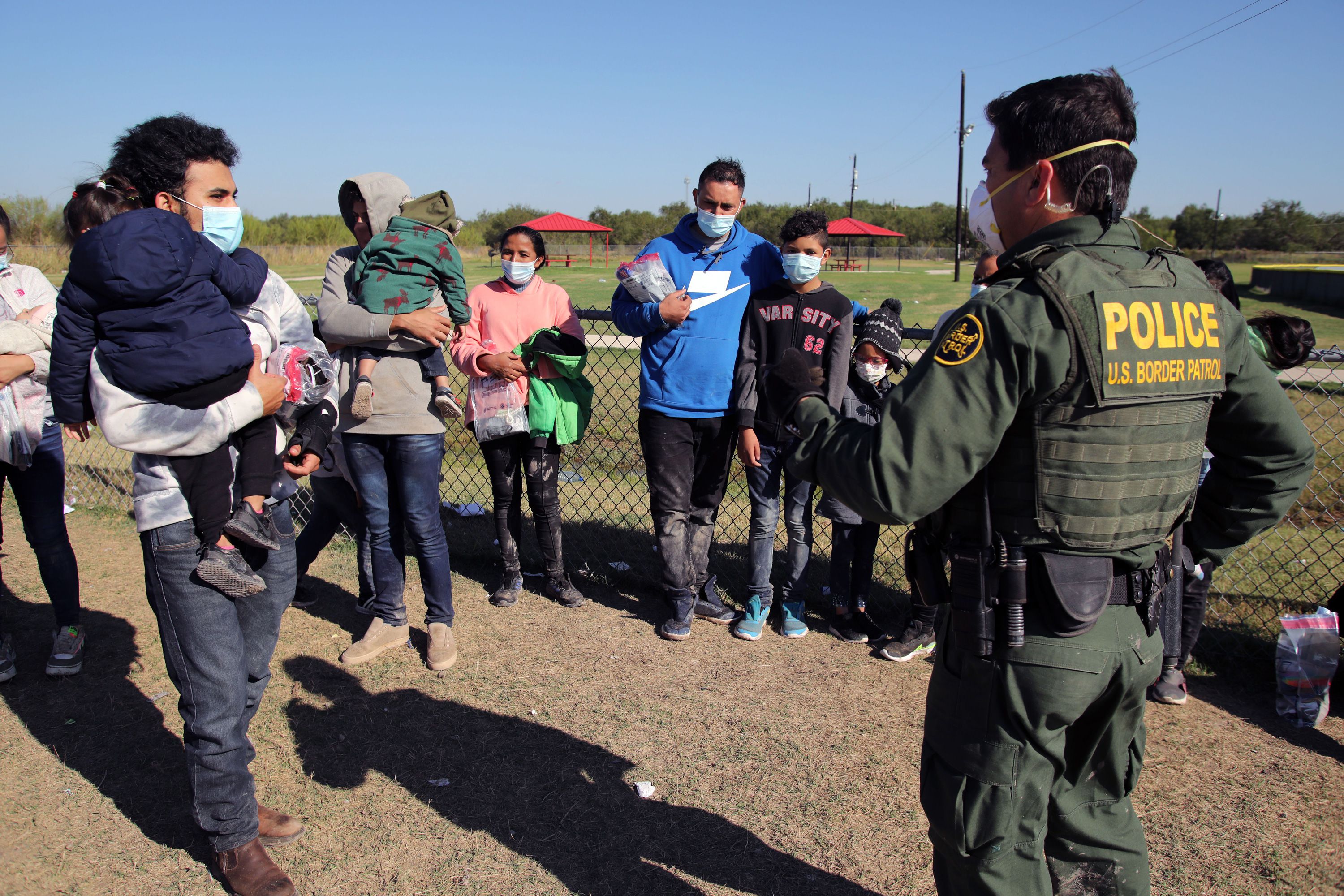 Honduran asylum seekers speak with a border patrol agent in La Joya, Texas, Nov. 16, 2021.