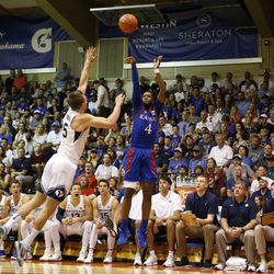 Kansas guard Isaiah Moss (4) attempts a 3-point shot over BYU guard Jake Toolson (5) during the first half of an NCAA college basketball game Tuesday, Nov. 26, 2019, in Lahaina, Hawaii.