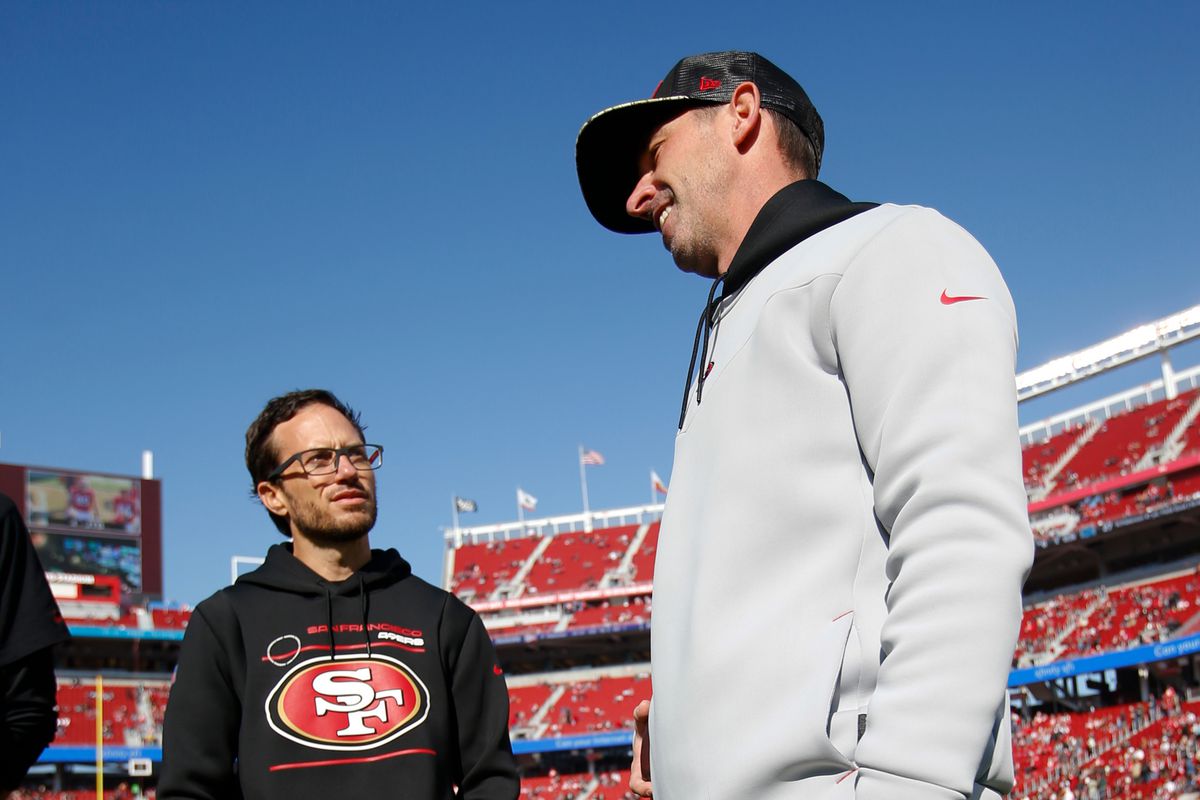 Offensive Coordinator Mike McDaniel and Head Coach Kyle Shanahan of the San Francisco 49ers on the field before the game against the Atlanta Falcons at Levi’s Stadium on December 19, 2021 in Santa Clara, California.