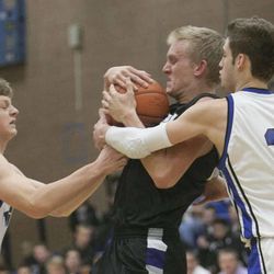 Bingham's Mike Green and teammate Ryan Turner try to get the ball away from Riverton's Bryce Stone Friday, Jan. 18, 2013. Bingham won 60-53.