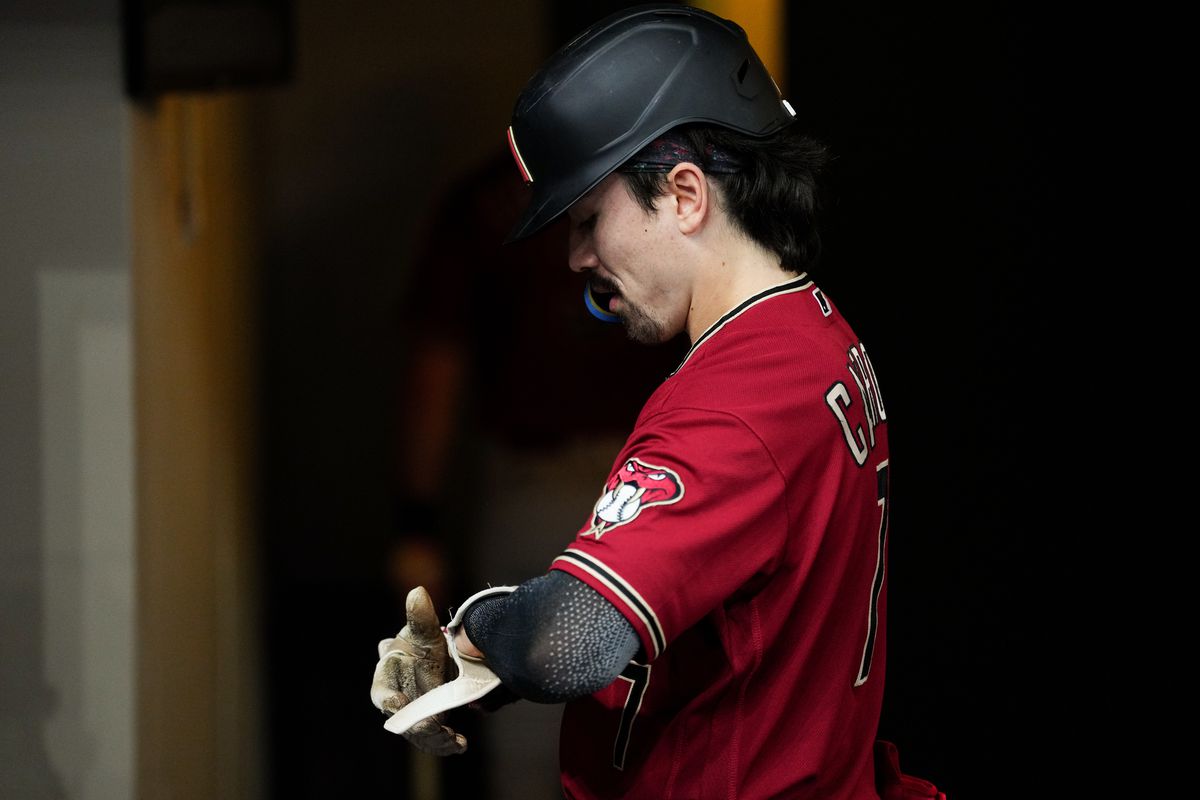 Corbin Carroll of the Arizona Diamondbacks prepares to bat in the dugout prior to Game 2 of the Wild Card Series between the Arizona Diamondbacks and the Milwaukee Brewers at American Family Field on Wednesday, October 4, 2023 in Milwaukee, Wisconsin.