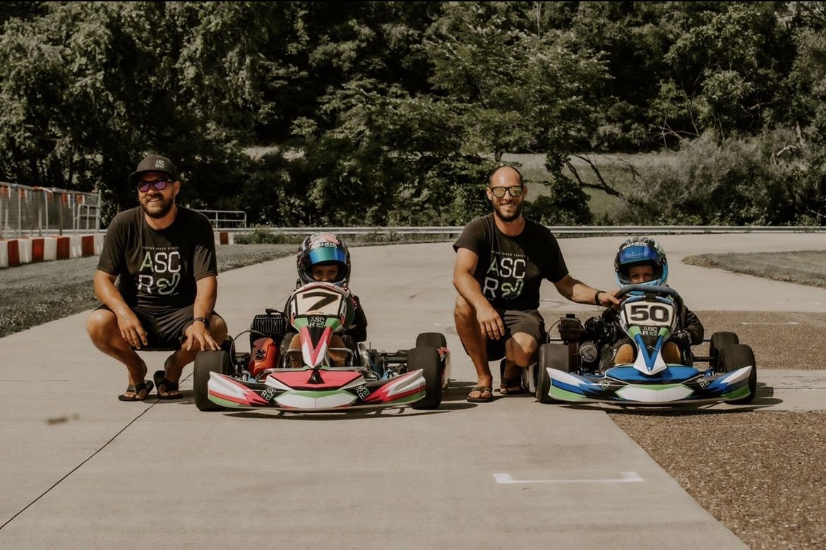 Brandon Adkins, second from right, with his husband and children at their race track.