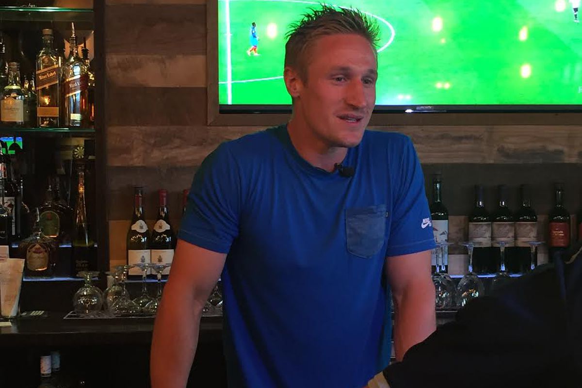 Tim Melia interacting with guest at the SKC Celebrity Bartending Fundraiser
