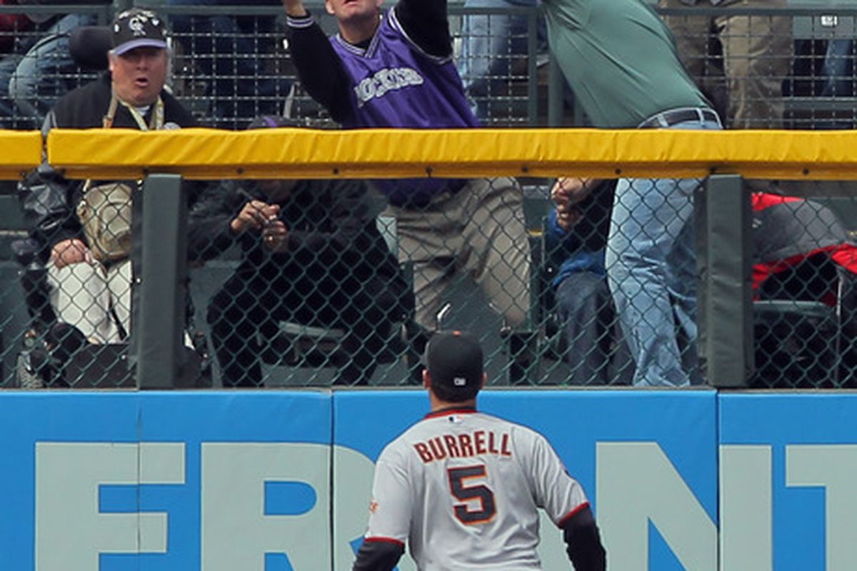 A Rockies fan catches a home run ball. Not pictured: the comely divorcée who caught Burrell's hotel key during batting practice