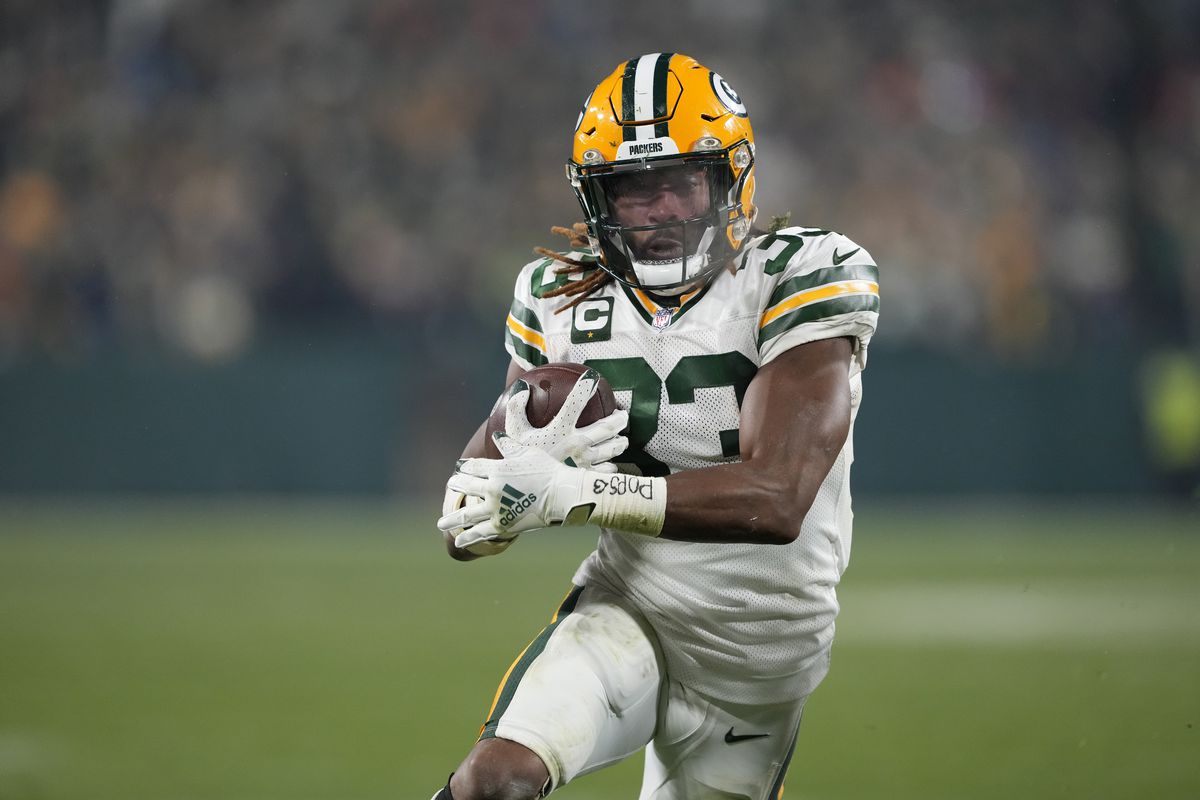 Aaron Jones #33 of the Green Bay Packers scores a two point conversion against the Tennessee Titans during the third quarter in the game at Lambeau Field on November 17, 2022 in Green Bay, Wisconsin.