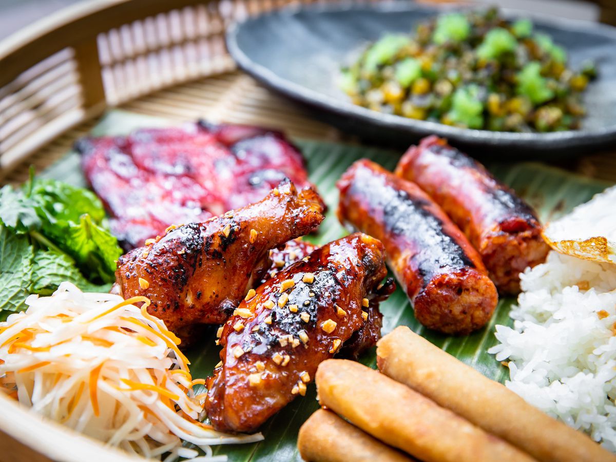 A tray with chicken wings, tocino, loganiza, and lumpia Shanghai.