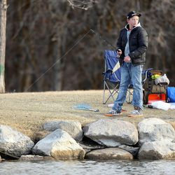 Easton Monsen braves the cooler temperatures Sunday, Feb. 22, 2015, as he fishes at the pond at Herriman Springs.