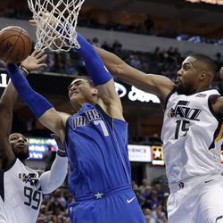 Utah Jazz forward Jae Crowder (99) and forward Derrick Favors (15) strips the ball away from Dallas Mavericks center Dwight Powell (7) on a shot attempt during the first half of an NBA basketball game Thursday, March 22, 2018, in Dallas. (AP Photo/Tony Gutierrez)
