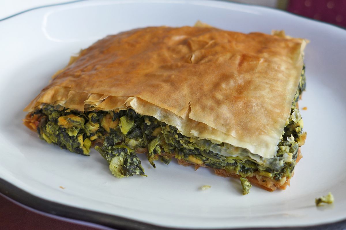 A browned square of filo stuffed with spinach.