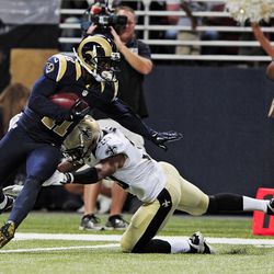 Aug 8, 2014; St. Louis, MO, USA; St. Louis Rams wide receiver Tavon Austin (11) breaks a tackle from New Orleans Saints defensive back Trevin Wade (30) during the first half at Edward Jones Dome. Mandatory Credit: Jeff Curry-USA TODAY Sports