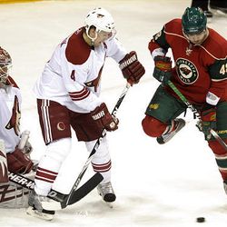 Minnesota Wild left wing Guillaume Latendresse, right, looks at a rebound as Phoenix Coyotes defenseman Zbynek Michalek, center, of the Czech Republic, defends in front of Coyotes goalie Ilya Bryzgalov, left, of Russia, during the first period.