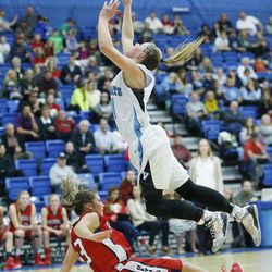 Sky View's Lindsey Jensen drives over Springville's Olivia Park in the 4A state girls basketball playoffs in Salt Lake County Tuesday, Feb. 17, 2015. 