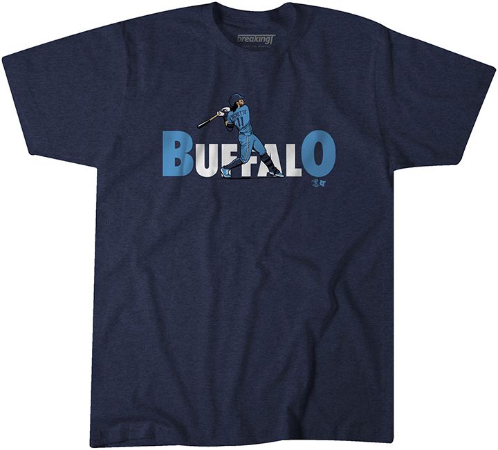 An illustration of Bo Bichette’s power swing while wearing the Toronto Blue Jays’ new powder blue jerseys is in the foreground in front of the letters “BUFFALO” printed on navy t-shirt. The letters “B” and “O” in larger type and in powder blue, the other letters in white. 