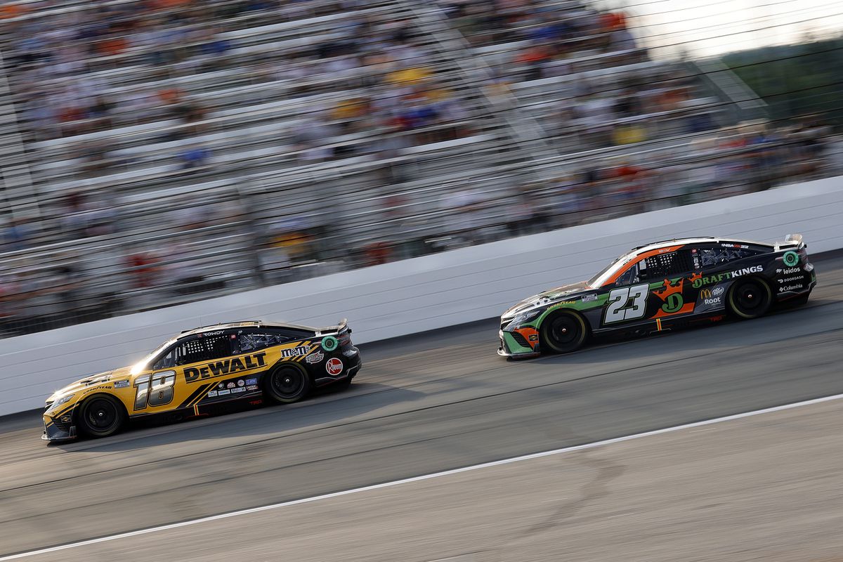 Kyle Busch, driver of the #18 DeWalt Toyota, and Bubba Wallace, driver of the #23 Draft Kings Toyota, race during the NASCAR Cup Series Ambetter 301 at New Hampshire Motor Speedway on July 17, 2022 in Loudon, New Hampshire.