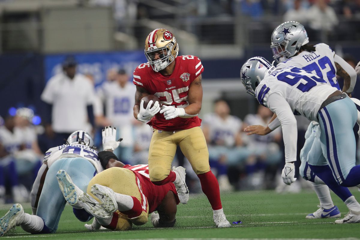 Elijah Mitchell #25 of the San Francisco 49ers rushes during the NFC Wild Card Playoff game against the Dallas Cowboys at AT&amp;T Stadium on January 16, 2022 in Arlington, Texas. The 49ers defeated the Cowboys 23-17.