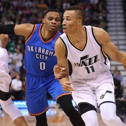 Utah Jazz guard Dante Exum (11) gets away from Oklahoma City Thunder guard Russell Westbrook (0) as the Jazz and the Thunder play at Vivint Smart Home arena in Salt Lake City on Wednesday, Dec. 14, 2016.