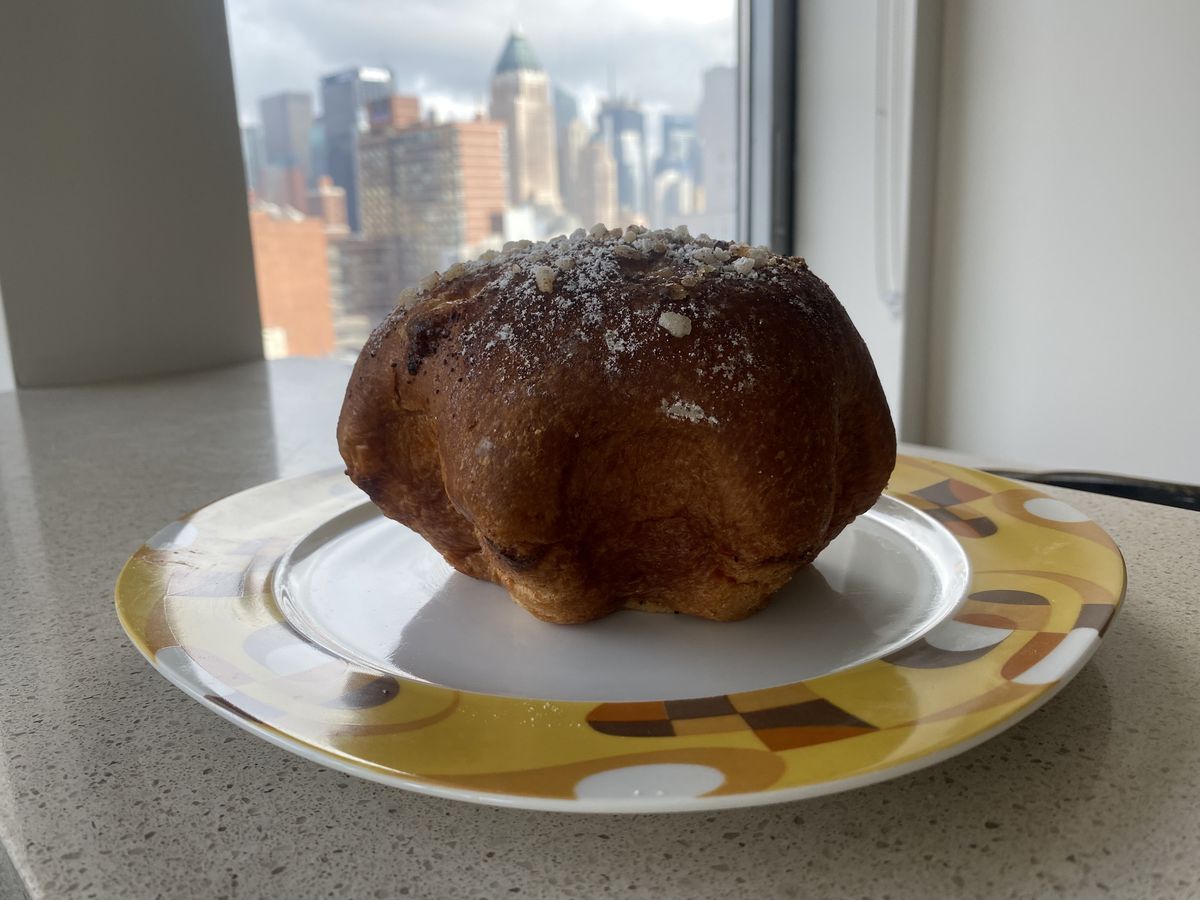 Brioche Bressane, shaped like a starfish and dotted with sugar, sits on a decorative plate
