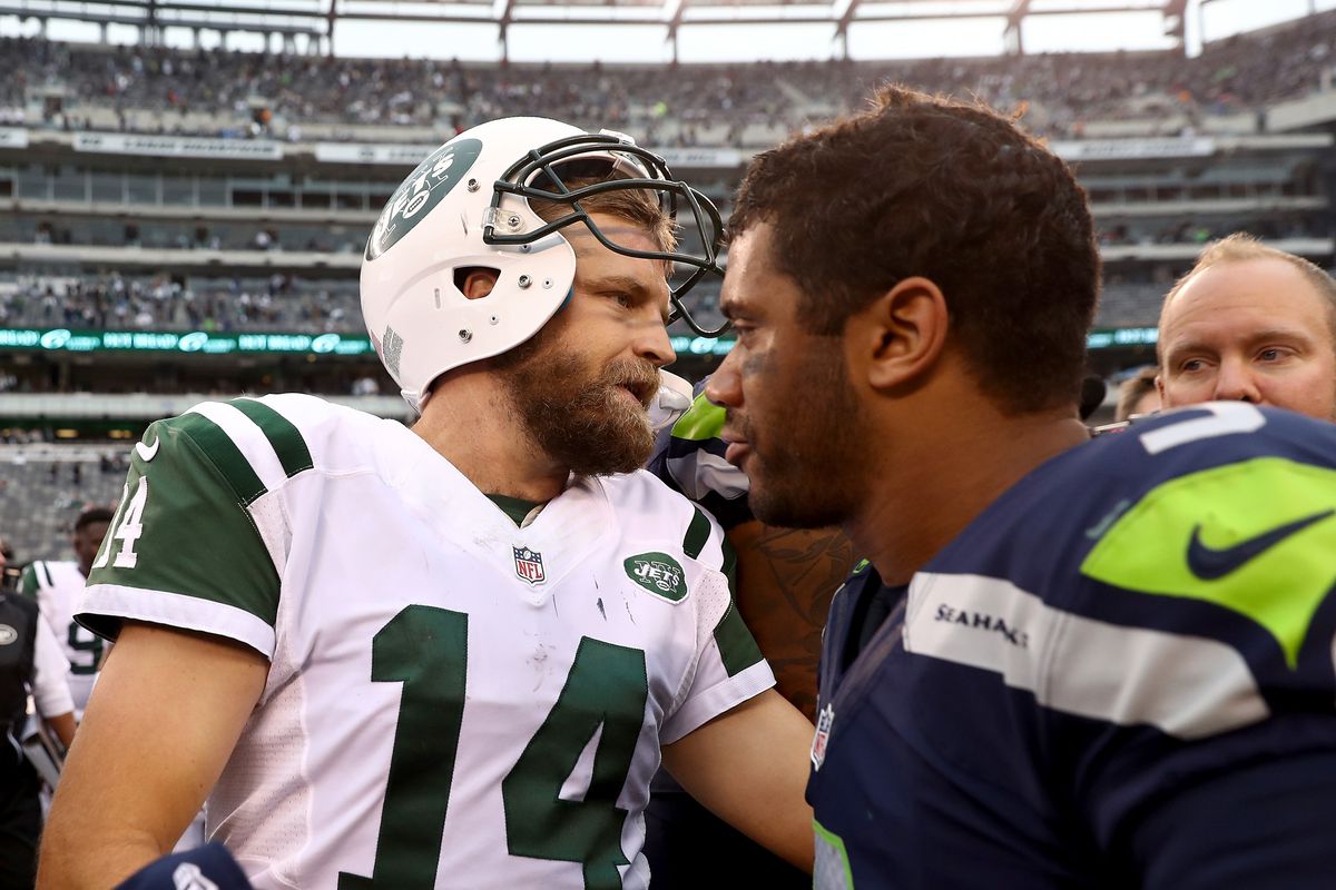 Ryan Fitzpatrick of the New York Jets and Russell Wilson of the Seattle Seahawks talk after the game at MetLife Stadium on October 2, 2016 in East Rutherford, New Jersey.