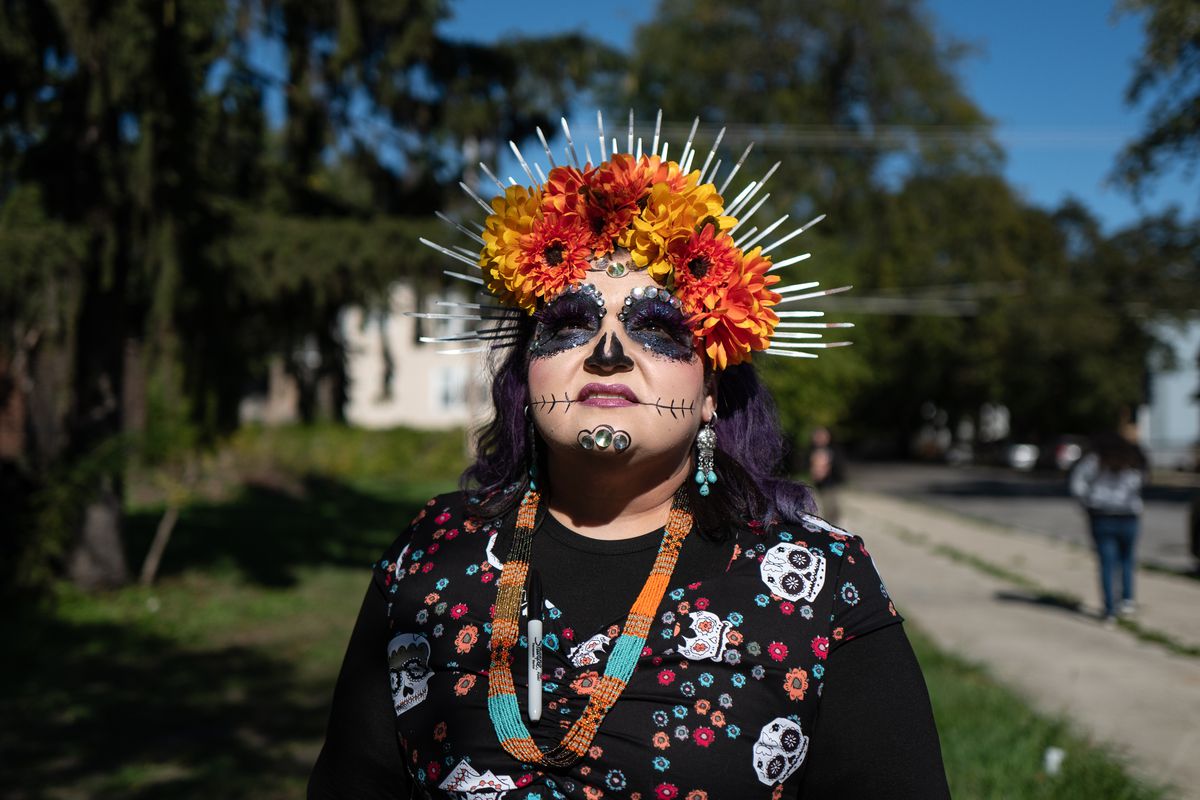 Nancy Salas-Herrera poses for a portrait during the 10th annual Back of the Yards Dia de los Muertos procession in the Southwest Side neighborhood, Saturday morning, October 23, 2021. The procession started at West 51st Street and South Elizabeth Street and ended with a display of “ofrendas” or altars, food and supplies distribution, dancing and a blessing ceremony by Aztec dancers outside The Plant at 1400 W. 46th St.