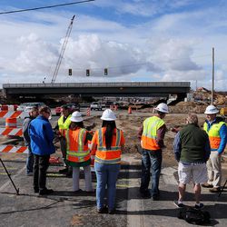 Members of the media conduct interviews as preparations are made Wednesday, March 9, 2016, to slide a bridge into place on I-15 over Hill Field Road in Layton. The bridge is to be  Wednesday night and early Thursday morning.