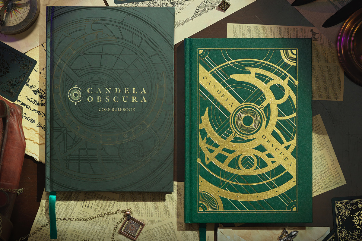 A photograph of the standard and special edition rulebooks for Candela Obscura, set down on a table where they’re surrounded by various Victorian-inspired curios