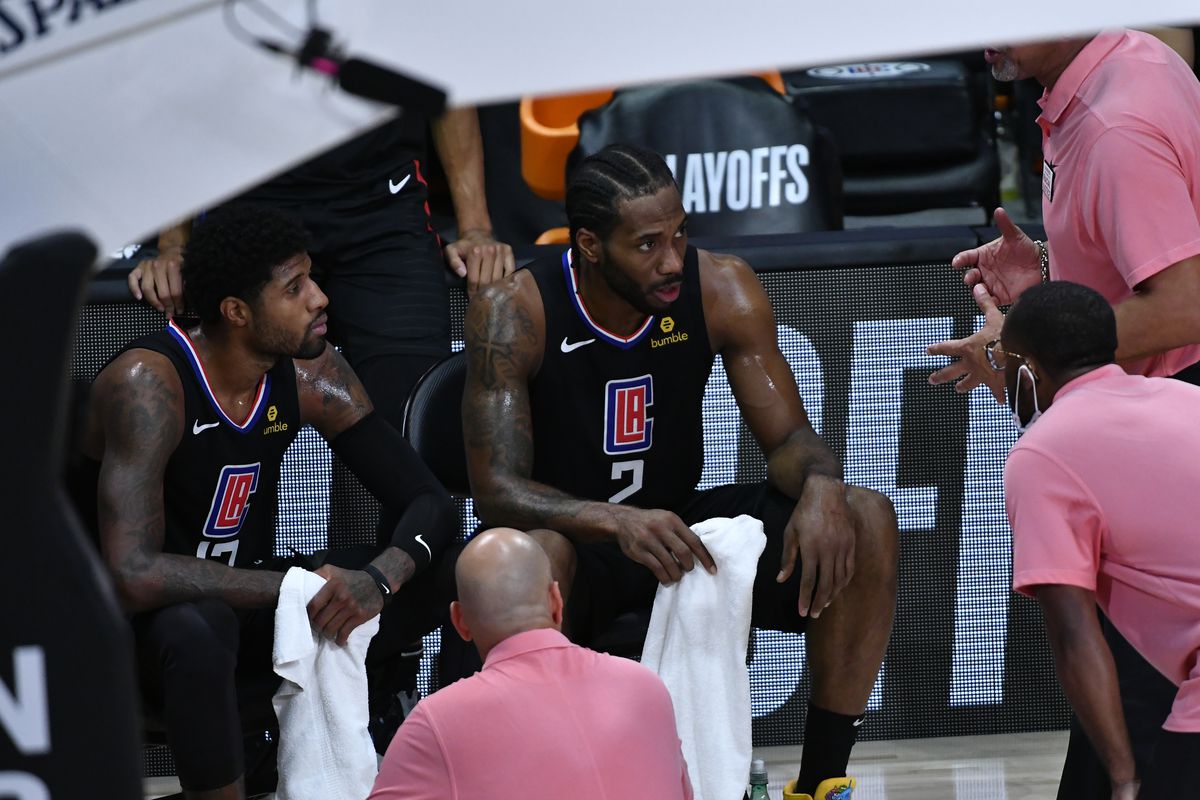 Paul George and Kawhi Leonard of the LA Clippers look on against the Denver Nuggets during Game Seven of the Western Conference SemiFinals of the NBA Playoffs on September 15, 2020 at AdventHealth Arena in Orlando, Florida.