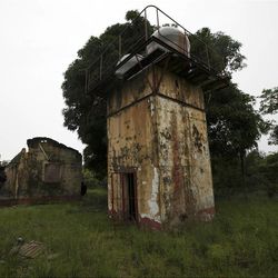In this photo taken Tuesday, May, 8. 2012, an abandoned water storage tank is seen at the former prison known as Tekunle on Ita Oko Island outside of Lagos, Nigeria.
