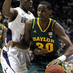 Baylor forward Quincy Miller (30) drives past BYU guard Charles Abouo (1) during the first half of an NCAA college basketball game, Saturday, Dec. 17, 2011, in Provo, Utah.