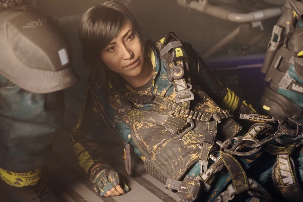 A Rainbow Six Extraction operator sitting up on the floor of a helicopter looking at her squadmates