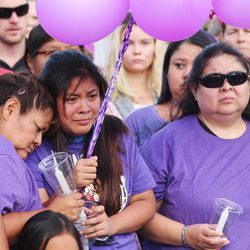 Deshaun Undergust, right, and her daughter Taylor grieve as a  candlelight vigil is held for her daughter Kailey Vijil in West Valley City Sunday, July 19, 2015. Police say Kailey, 12, was killed by a 15-year-old neighbor on Friday.
