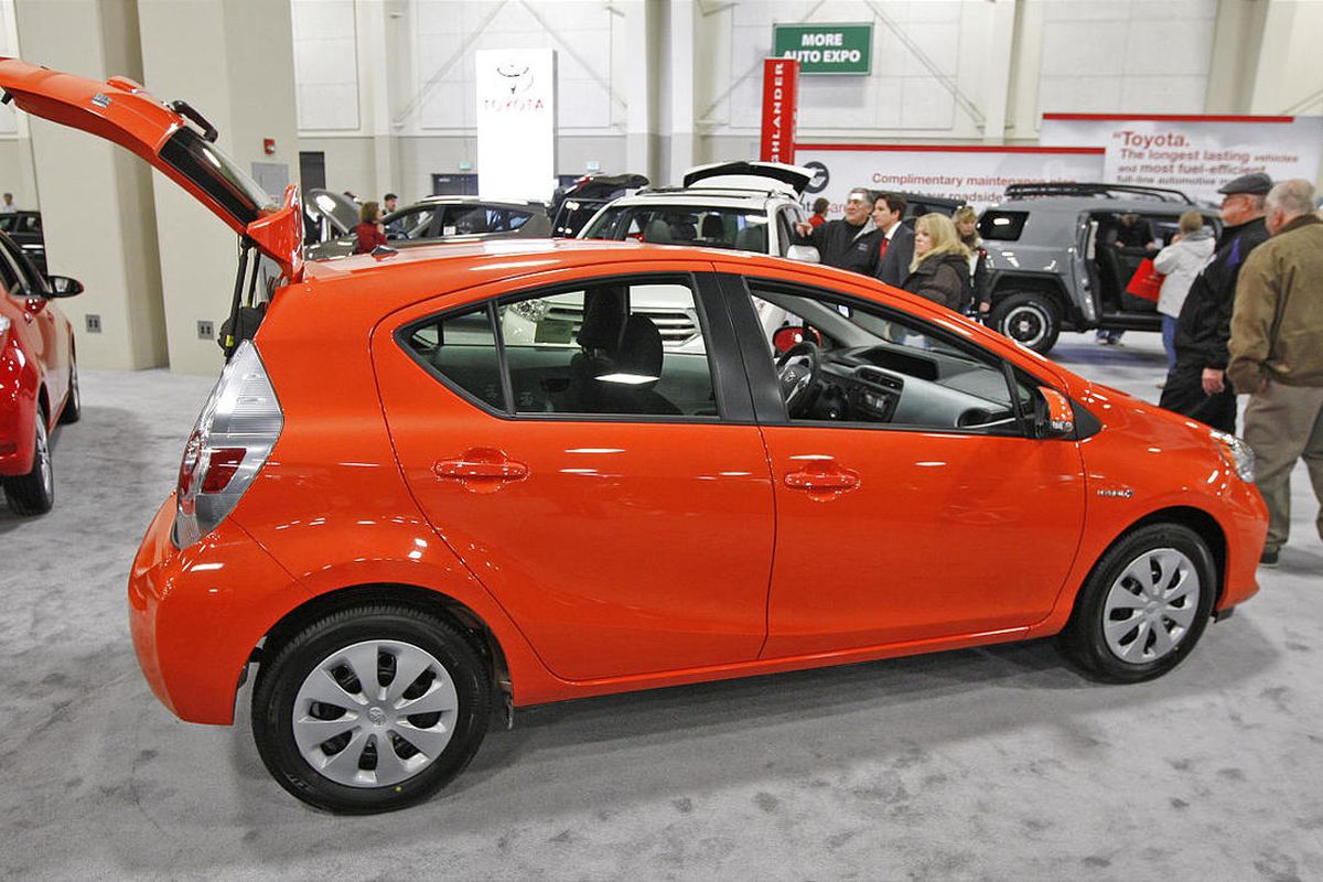 Car buffs check out a Toyota Prius at the Utah Auto Expo at the SouthTowne Expo Center.