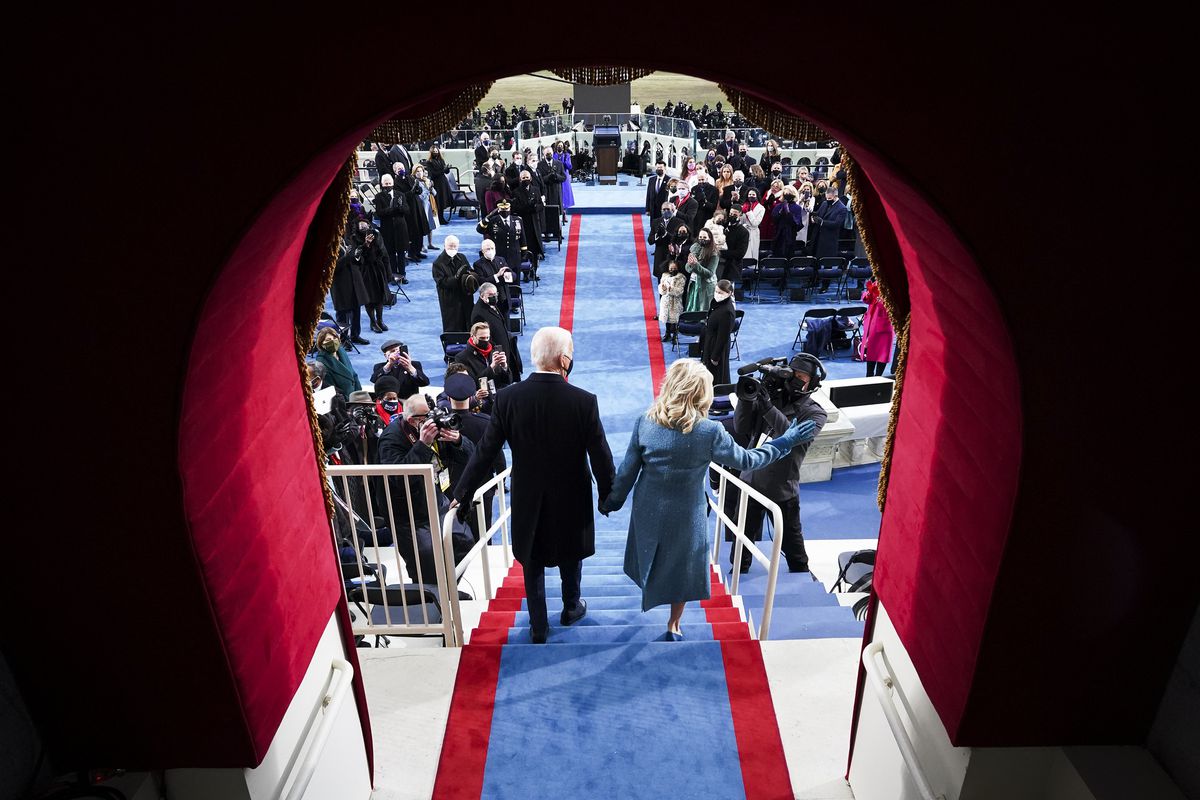 Joe and Jill Biden enter the inauguration stage at the Capitol.