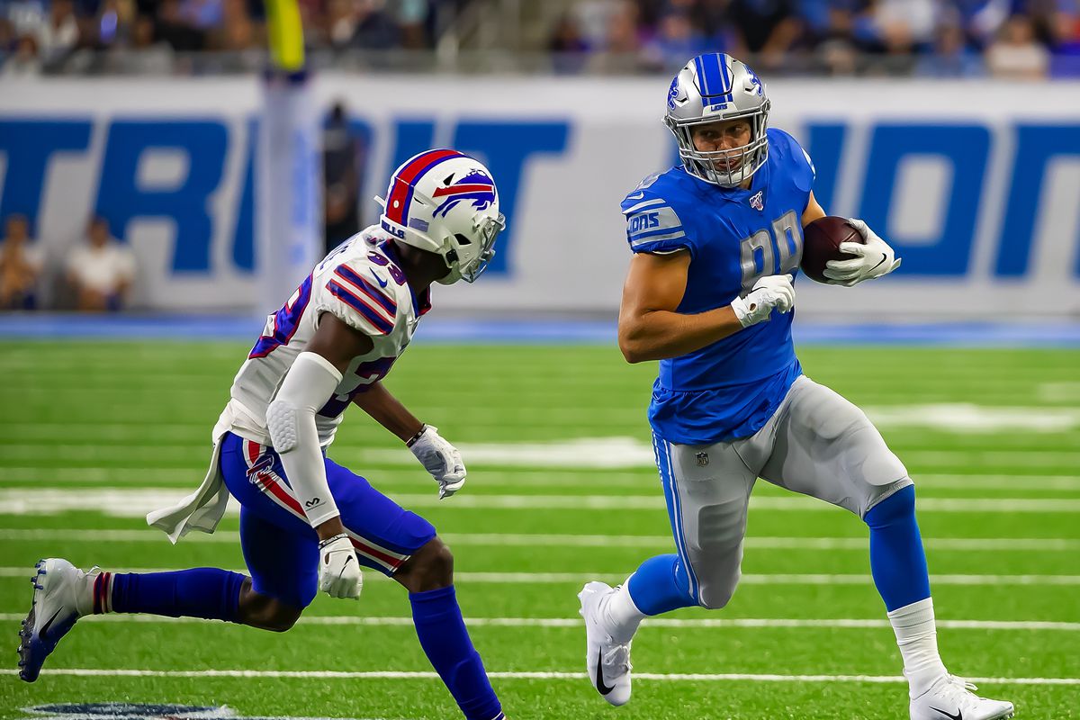 Rookie tight end T.J. Hockenson of the Detroit Lions runs with the football in front of cornerback Levi Wallace of the Buffalo Bills following a catch during the 1st half of an NFL preseason game at Ford Field on August 23, 2019 in Detroit, Michigan.