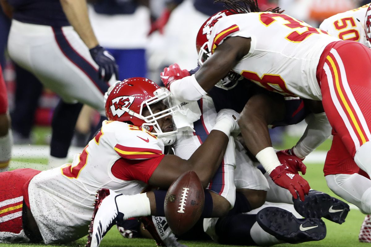 Kansas City Chiefs defensive end Chris Jones forces Houston Texans running back D’Onta Foreman to fumble during the second quarter at NRG Stadium.