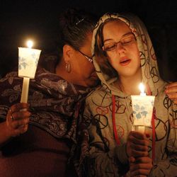 Cheryl Gambill, left, and her daughter Georgia, participate in a vigil for Charlie and Braden Powell at the Josh Powell home in Graham, Washington, Saturday, Feb. 11, 2012.