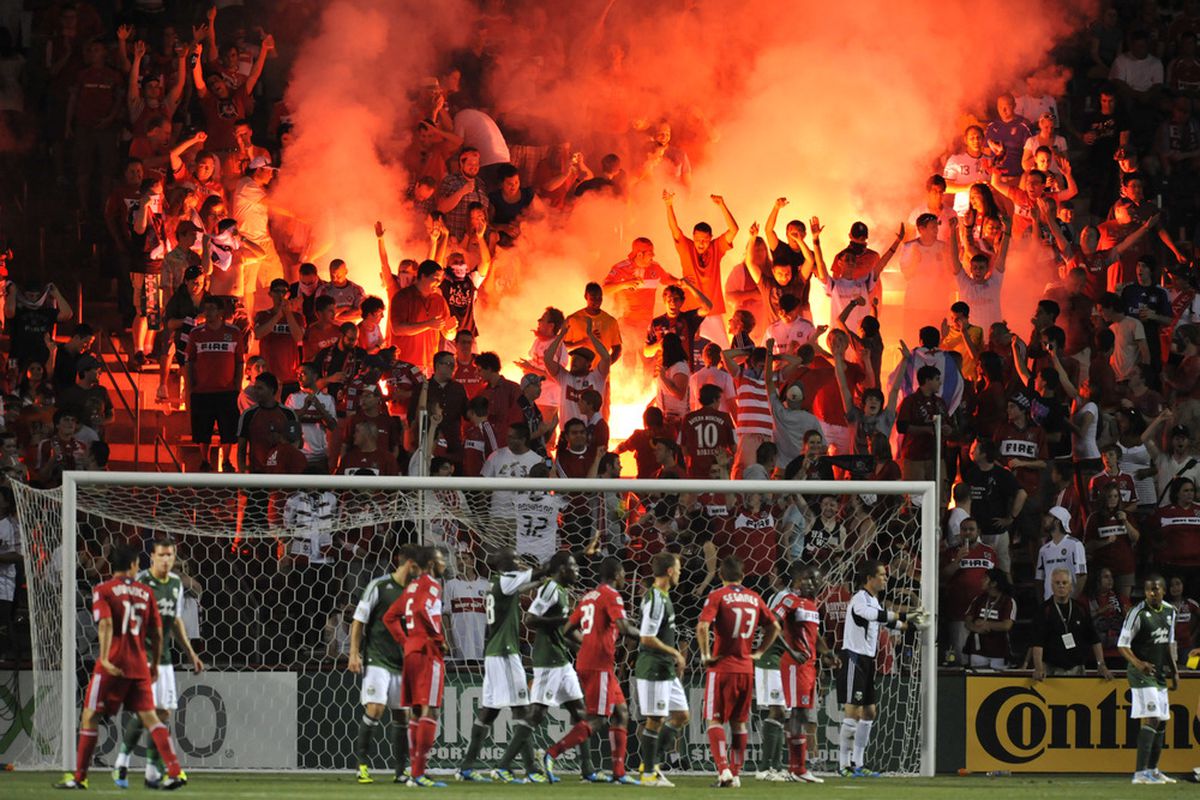 BRIDGEVIEW, IL - JULY 16: Chicago Fire fans light flares during the match between the Chicago Fire and the Portland Timbers during an MLS match on July 16, 2011 at Toyota Park in Bridgeview, Illinois. (Photo by David Banks/Getty Images)