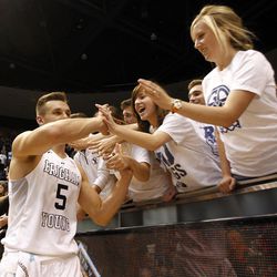 Brigham Young Cougars guard Kyle Collinsworth (5) gives high fives to BYU students after winning the first round of the NIT versus the UAB Blazers at the Marriott Center in Provo, Wednesday, March 16, 2016.