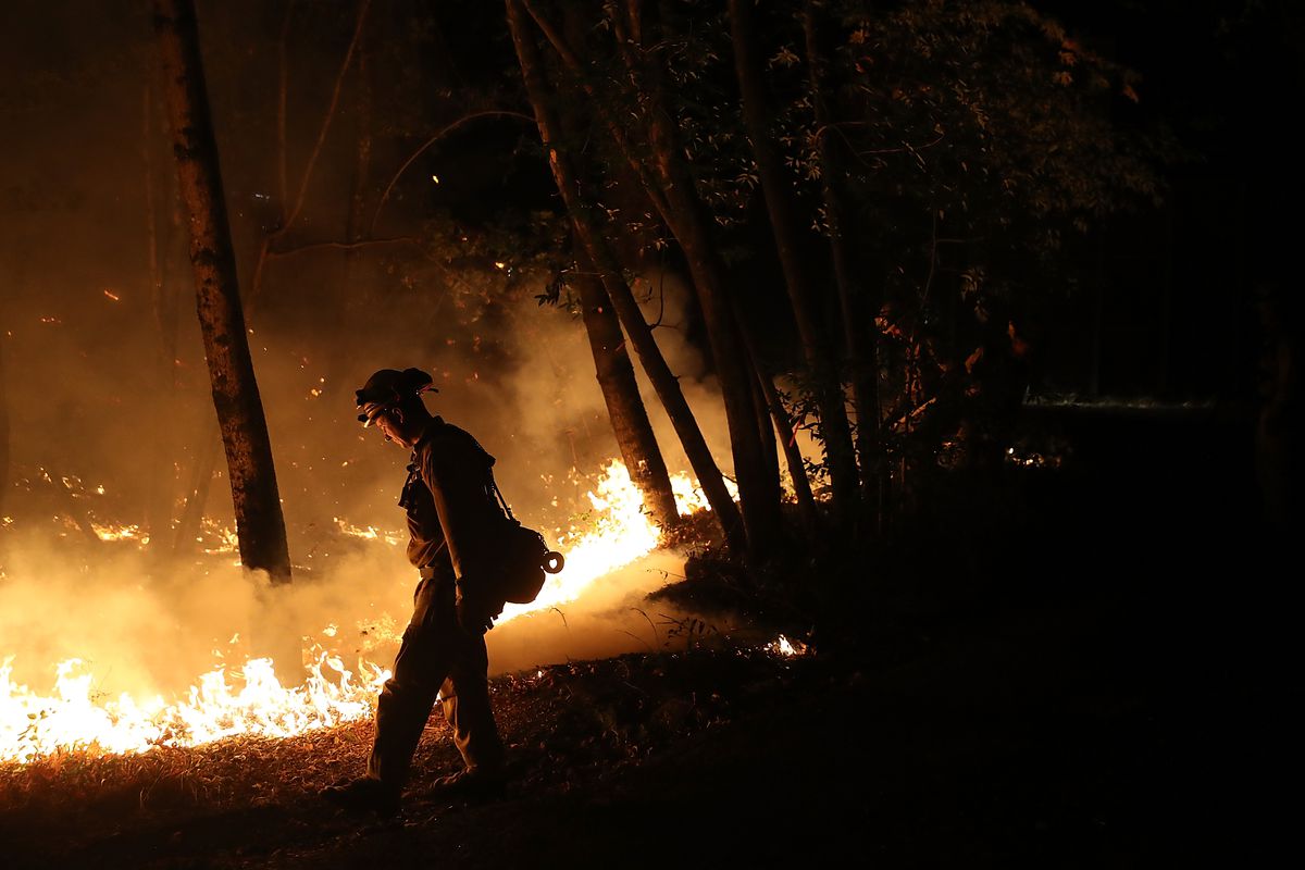 CalFire firefighter Brandon Tolp uses a drip torch during a firing operation while battling the Tubbs Fire.