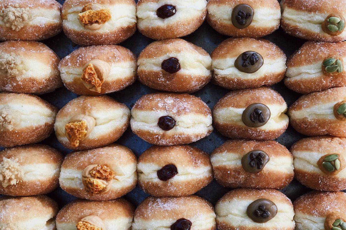 Rows of filled doughnuts stacked on top of each other from The Flour Box