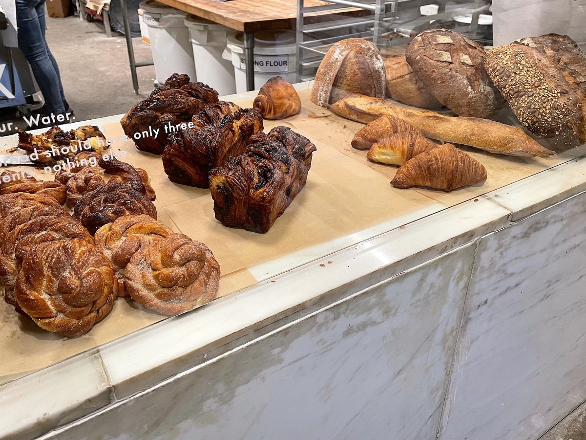 Buns, croissants, and breads on butcher paper