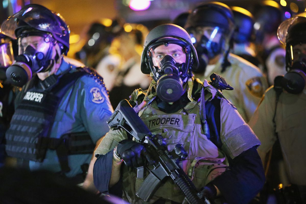 A police officer watches over demonstrators in Ferguson, Missouri.