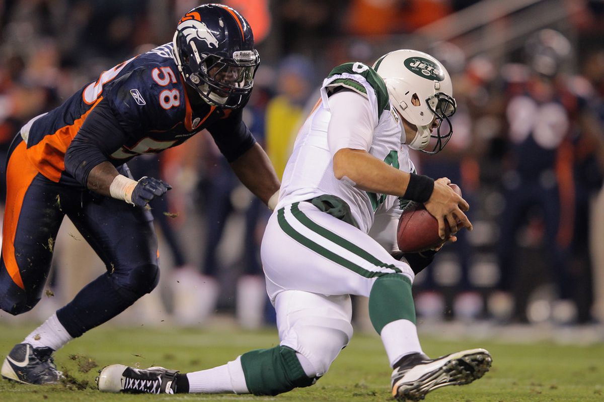 Mark Sanchez of the New York Jets recovers a fumbled snap in the second quarter against Von Miller of the Denver Broncos at Invesco Field at Mile High on November 17, 2011 in Denver, Colorado.  (Photo by Doug Pensinger/Getty Images)