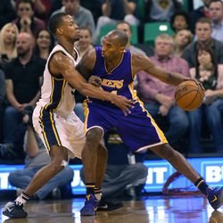 Los Angeles Lakers Kobe Bryant keeps the ball from the Utah Jazz's Rodney Hood at the Vivint Smart Home Arena in Salt Lake City on Monday, March 28,  2016.  