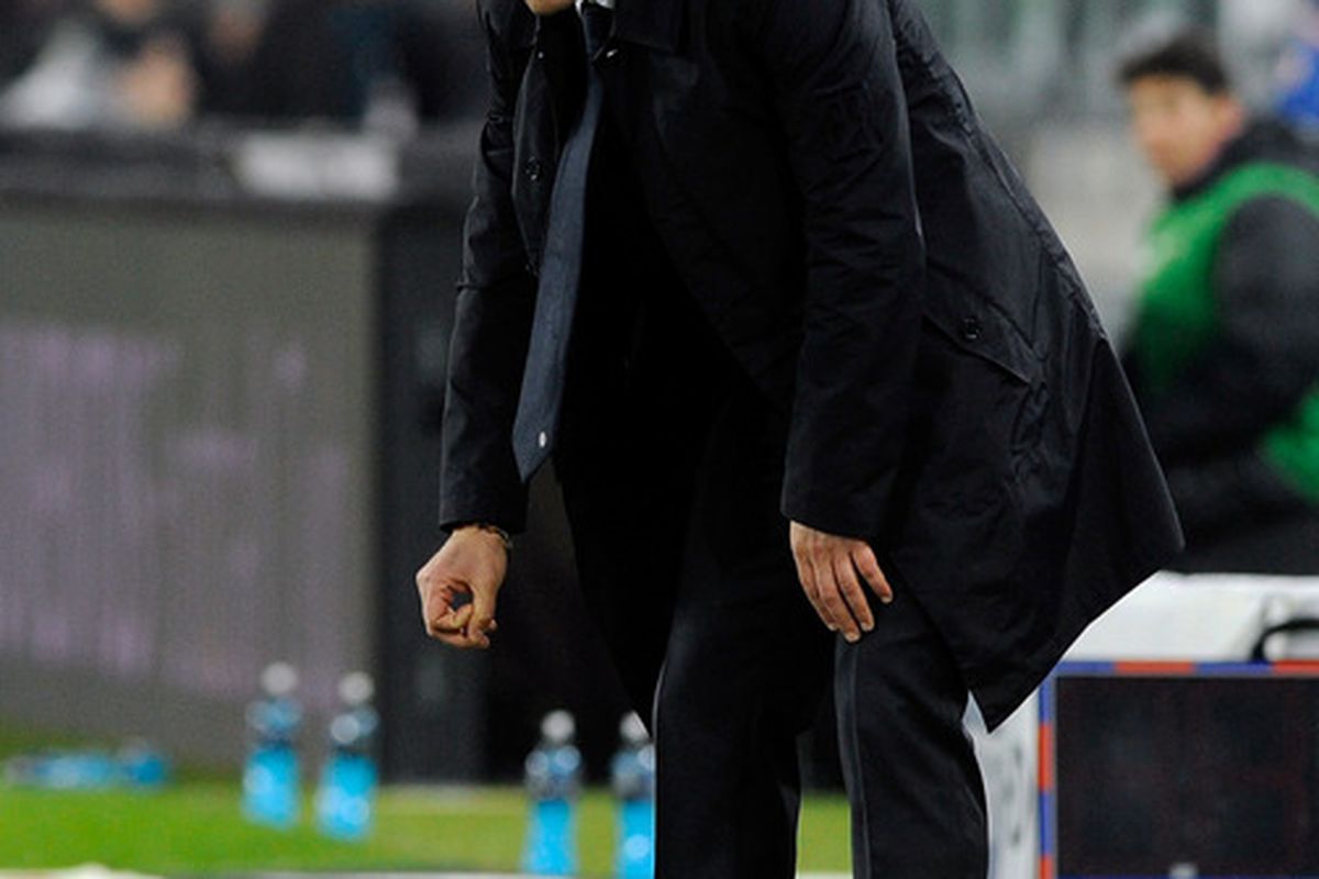 Even the once-mighty and invincible Conte is not immune to Mirko Vucinic's soul-sucking, dream-crushing, succubus antics.  (Photo by Claudio Villa/Getty Images)