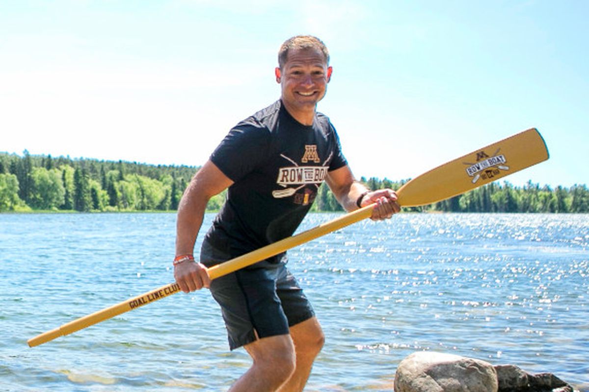 P.J. Fleck holding an oar