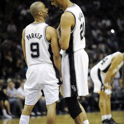 San Antonio Spurs guard Tony Parker of France, left, shares a laugh with forward Tim Duncan before tipoff of their game with the Miami Heat in an NBA basketball game at the AT&T Center in San Antonio, Friday, March 4, 2011. Parker played in his first game back after a calf contusion.  