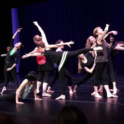 Members of an adult class from the University of Utah's Tanner Dance perform on stage.