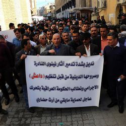 Iraqis hold a protest a day after Islamic State militants posted an online video showing them smashing rare ancient artifacts in a museum, in Baghdad, Iraq, Friday, Feb. 27, 2015. The protesters held a banner denouncing the destruction of the artifacts and call upon the Iraqi government to protect archeological sites in the country. 