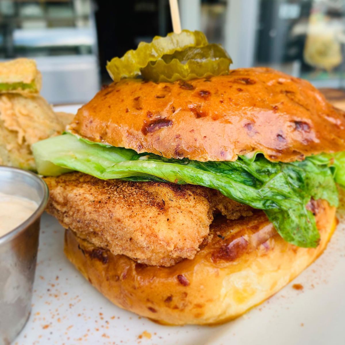 Fried chicken sandwich topped with bread and butter pickles and Creole mayo from Bantam and Biddy in Atlanta. 