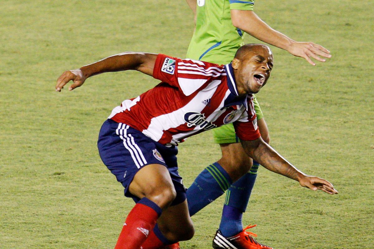 CARSON, CA - AUGUST 25: Ben Zemanski #21 of Chivas USA is tripped by Osvaldo Alonso #6 of Seattle Sounders FC during the MLS match at The Home Depot Center on August 25, 2012 in Carson, California. (Photo by Ric Tapia/Getty Images)